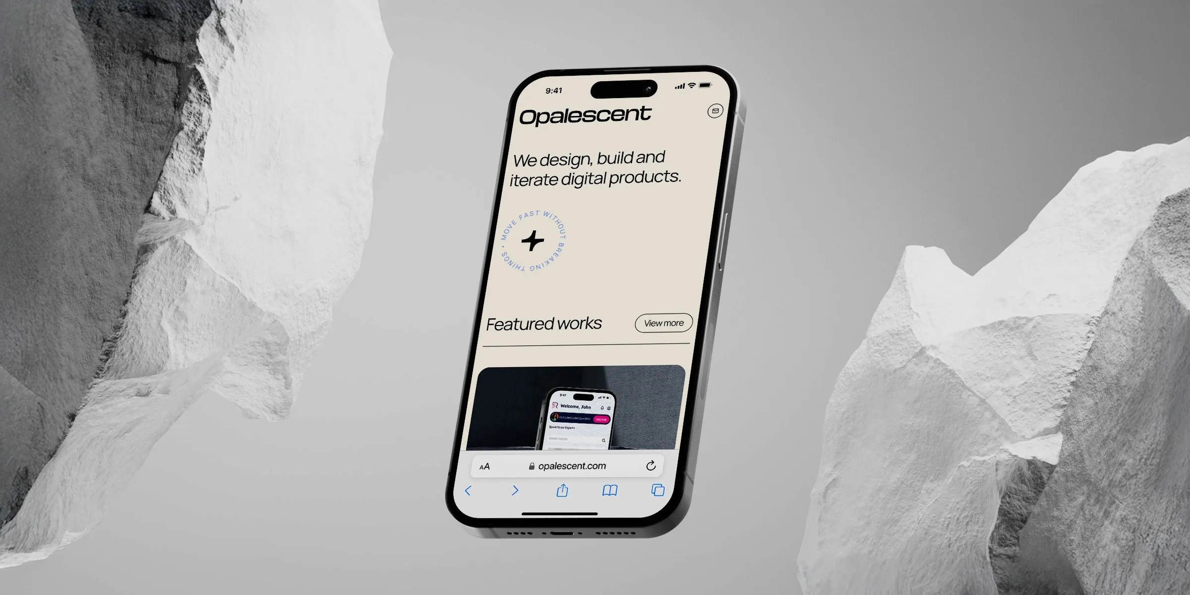 A sleek smartphone displaying the homepage of a minimalist digital design studio website called Opalescent, featuring modern typography and a neutral color palette, set against a grayscale background with rugged rock formations, highlighting a creative and innovative vibe.