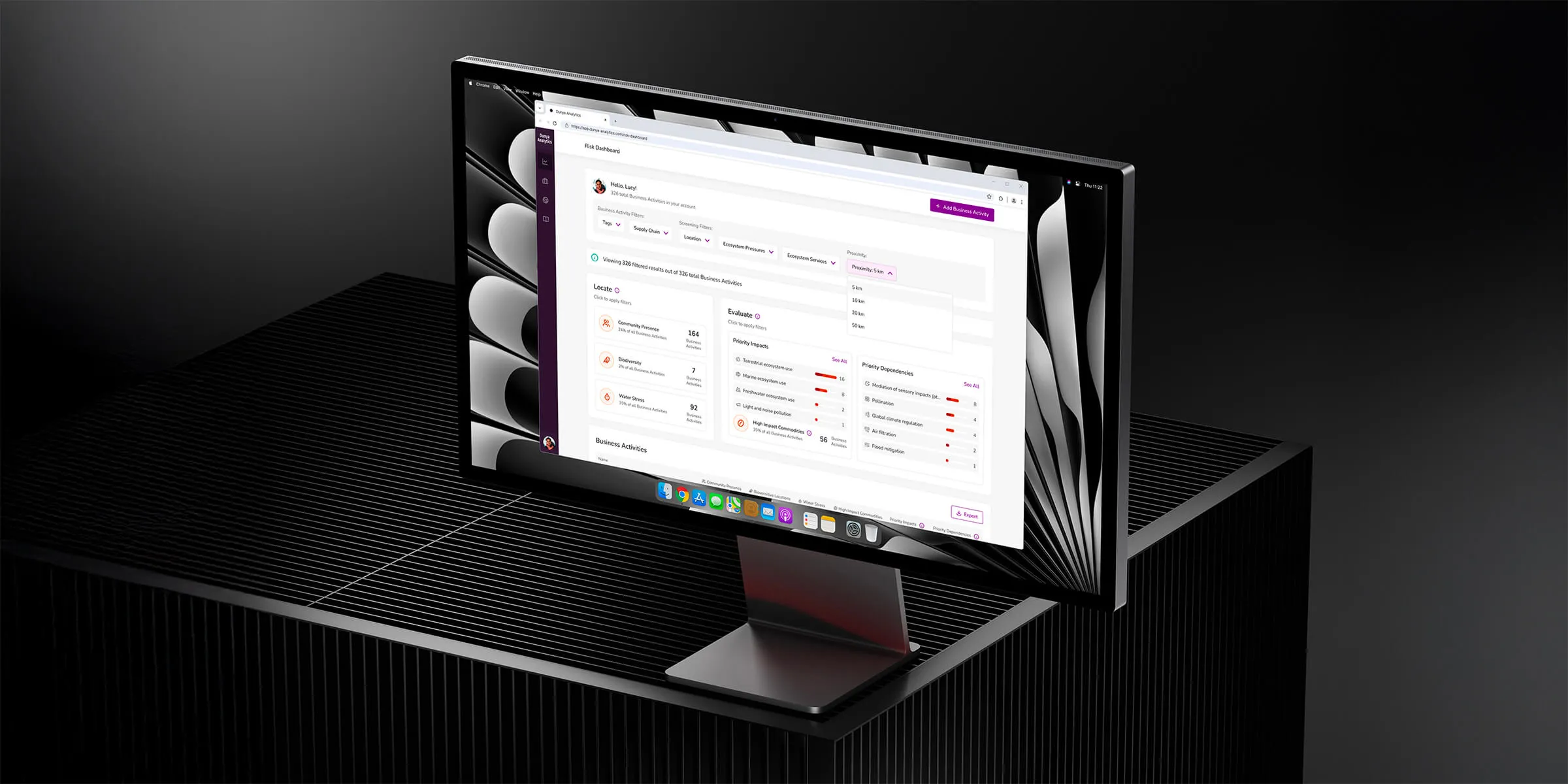 A sleek computer monitor displays a modern web application dashboard for Dunya Analytics, featuring organised data tables, vibrant icons, and a user-friendly interface on a dark, minimalist desk background.