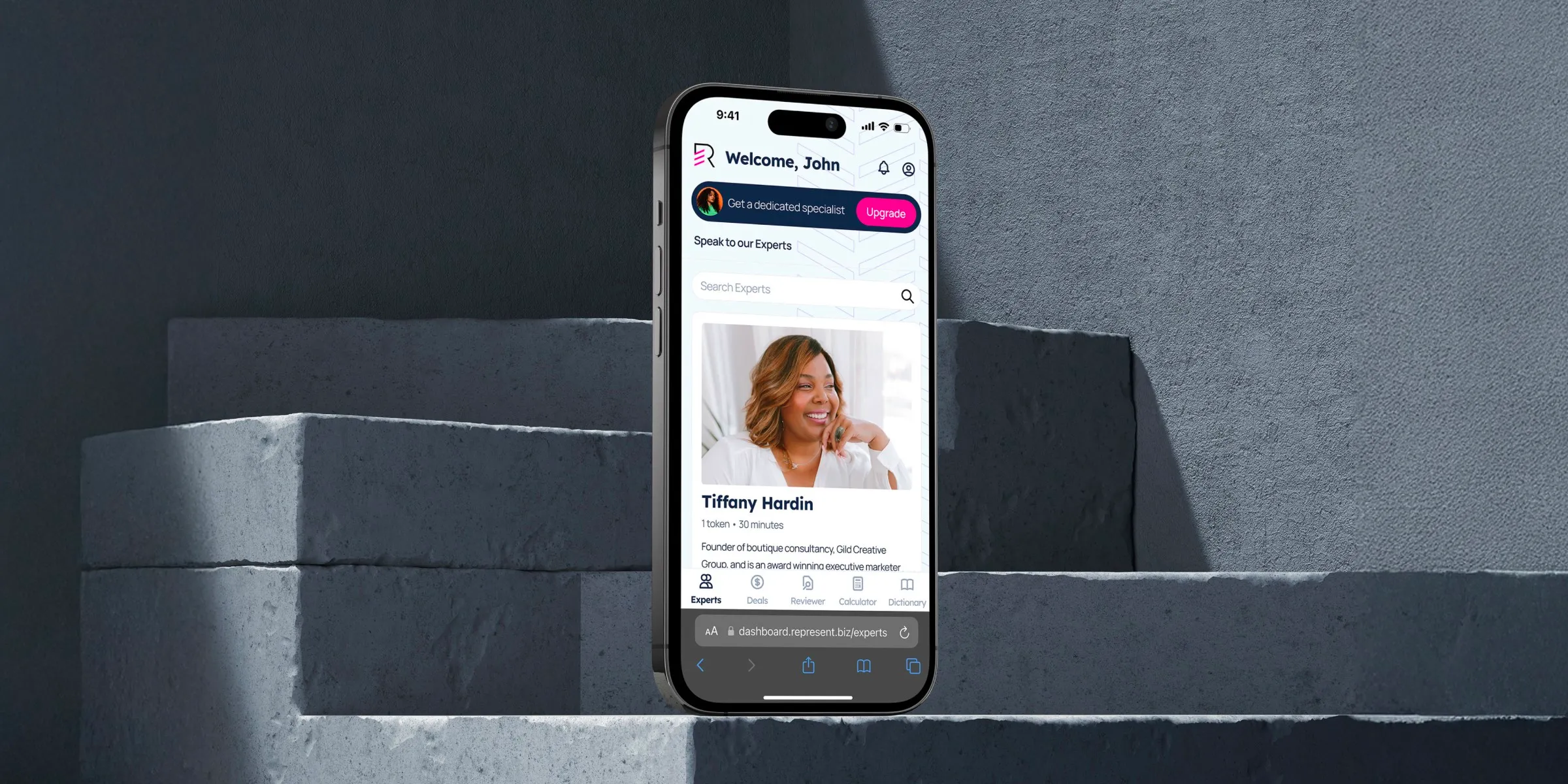 A smartphone displaying Represent, a professional networking app profile is placed on concrete steps, emphasising the digital talent market connection.
